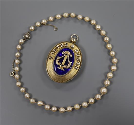A cultured pearl and diamond set clasp necklace and silver gilt masonic pendant.